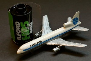 a toy airplane next to a film roll