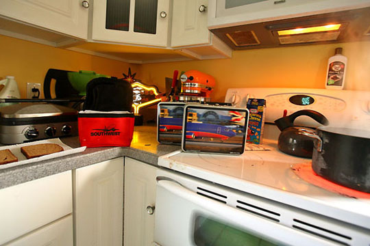 a kitchen with a microwave oven and a kettle