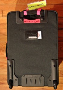 a black suitcase with pink straps