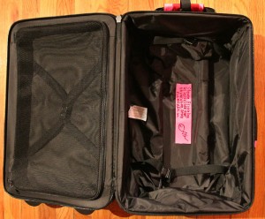 a black suitcase with a pink label