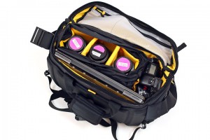 a bag with camera lenses and a camera