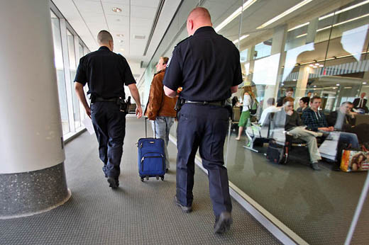 a group of police officers walking with luggage