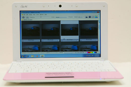 a white laptop with a pink keyboard