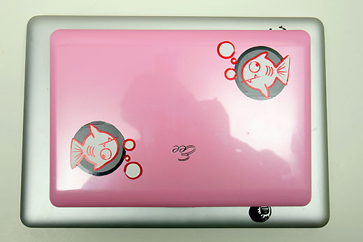 a pink laptop with fish stickers