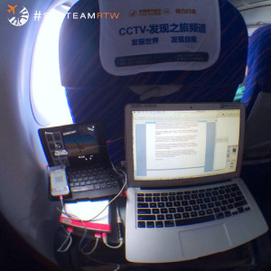 a laptop and cell phone on a plane