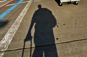 a shadow of a person with a luggage bag