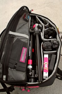 a bag with a camera and tripod inside