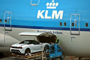 a car being loaded into an airplane