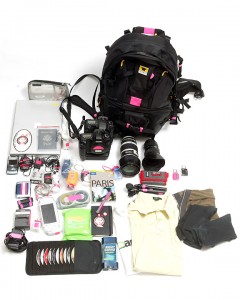 a backpack and other items laid out on a white surface