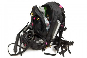 a black backpack with a camera and a laptop