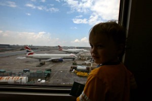 a child looking out a window at airplanes