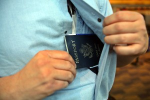a man putting a passport in his shirt