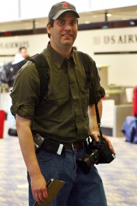 a man carrying a camera