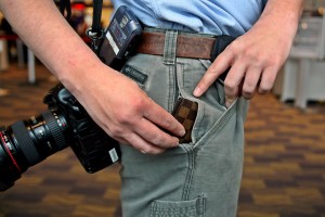 a person holding a camera and a pocket