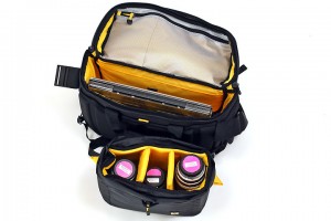 a black and yellow bag with a laptop and other items inside