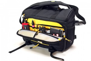 a black and yellow bag with tools inside