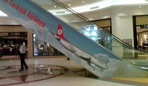 an escalator with an airplane on it