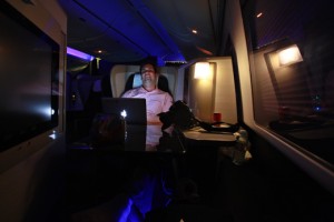 a man sitting in a chair with a laptop