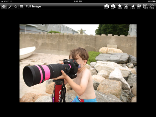 a child holding a large camera