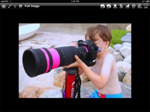 a boy with a large camera