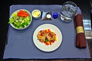 a plate of salad and a glass of water