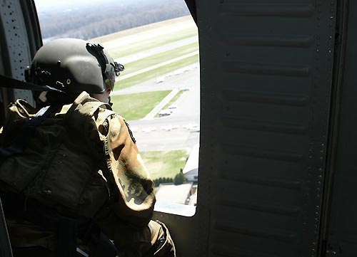 a soldier sitting in a helicopter