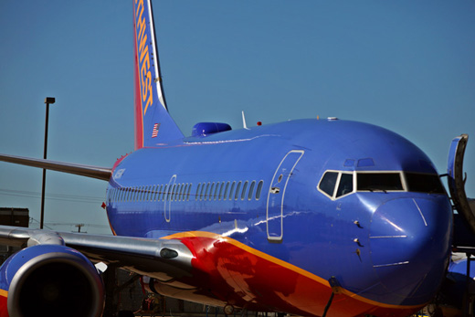 a blue airplane with red and yellow stripes