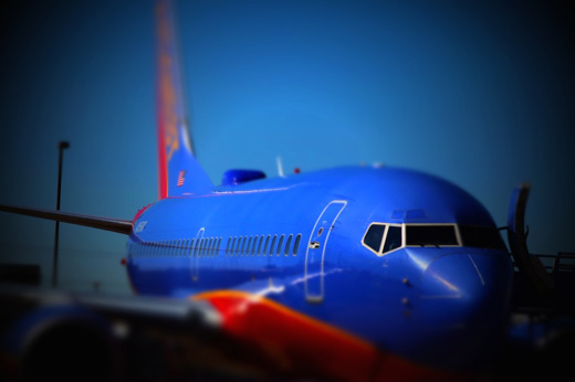 a blue airplane with red and orange tail