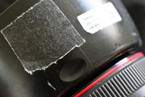 a black square with a white label on the side of a camera