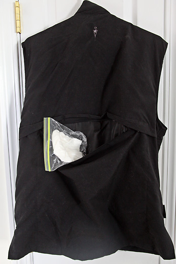 a black vest with a bag of cotton in it