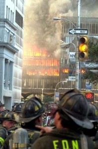a group of firefighters watching a building on fire