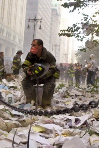 a firefighter sitting on a chair in a city