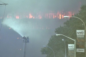 a firefighter spraying water on a building