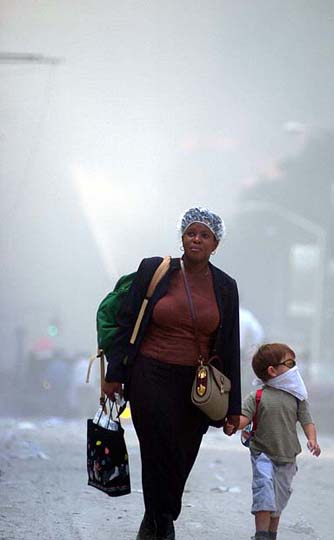 a woman and child walking in the fog