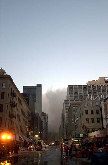 a city street with buildings and smoke