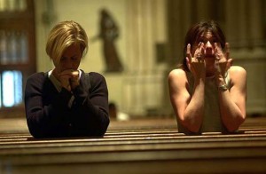 a woman and man sitting in a church