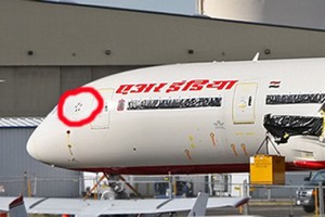 a white airplane with red circle on it