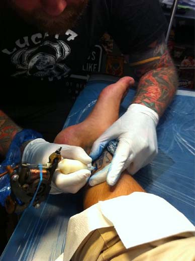a person getting a tattoo on their leg