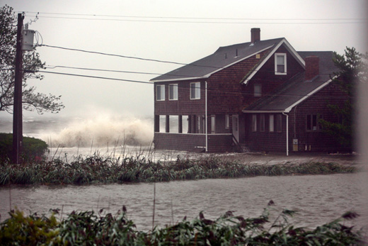 a house with a large wave crashing on it