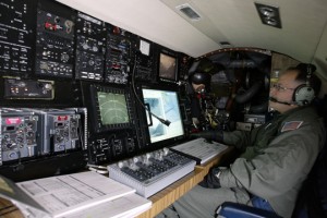 a man in a cockpit with a computer