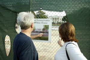a man and woman looking at a sign