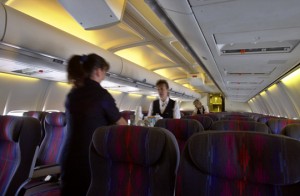 a flight attendant serving food on an airplane