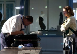a man and woman looking at luggage