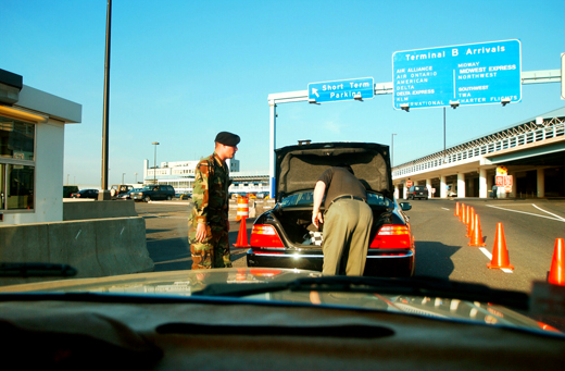 a man looking at a car with its trunk open