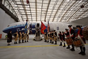 a group of people in uniform standing in front of an airplane
