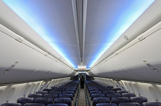 inside an airplane with blue seats