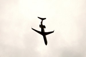 a silhouette of a plane in the sky