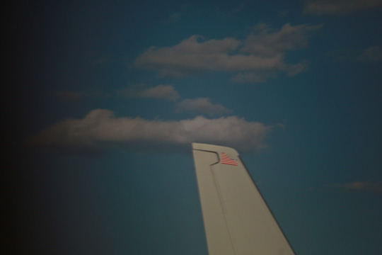 a plane's tail and clouds