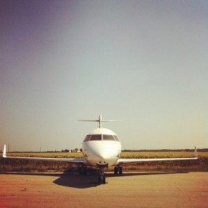 a white airplane on a runway