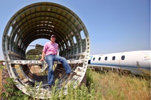 a man sitting on a metal tube